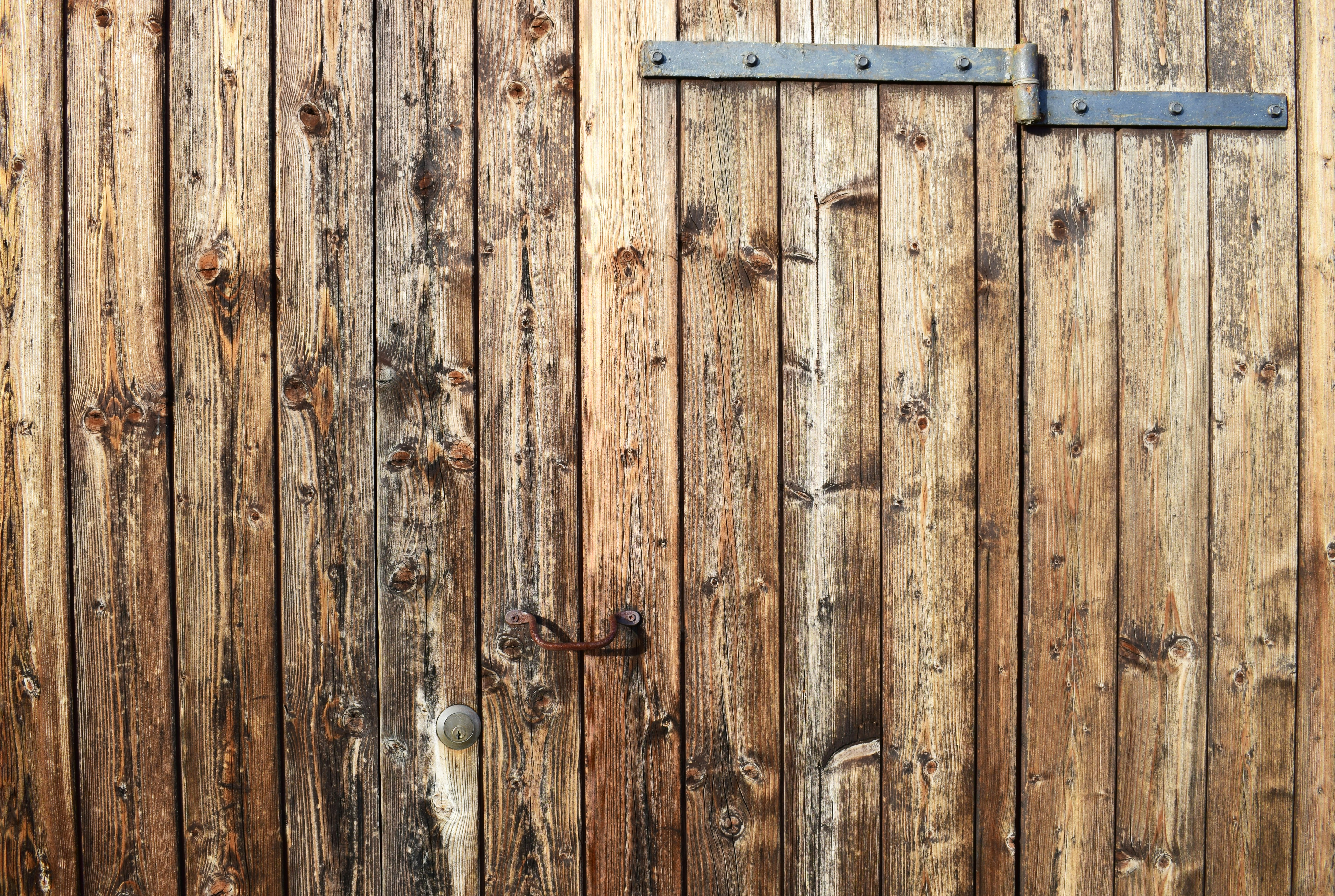 brown wooden door with grey hinges